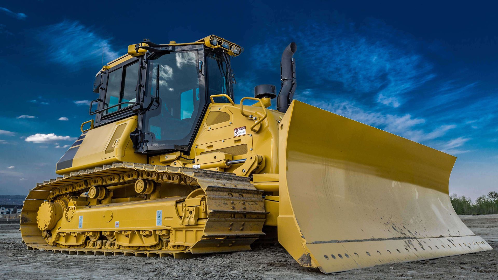 heavy duty bulldozer with blue sky; bulldozer with glass cab