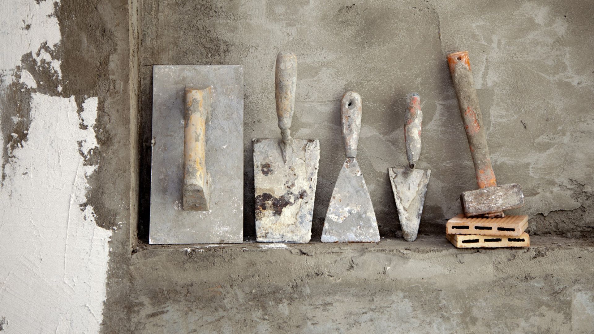 aged construction cement used tools grunge on mortar wall