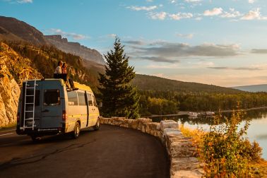 Women enjoying camper van with a view of a lake