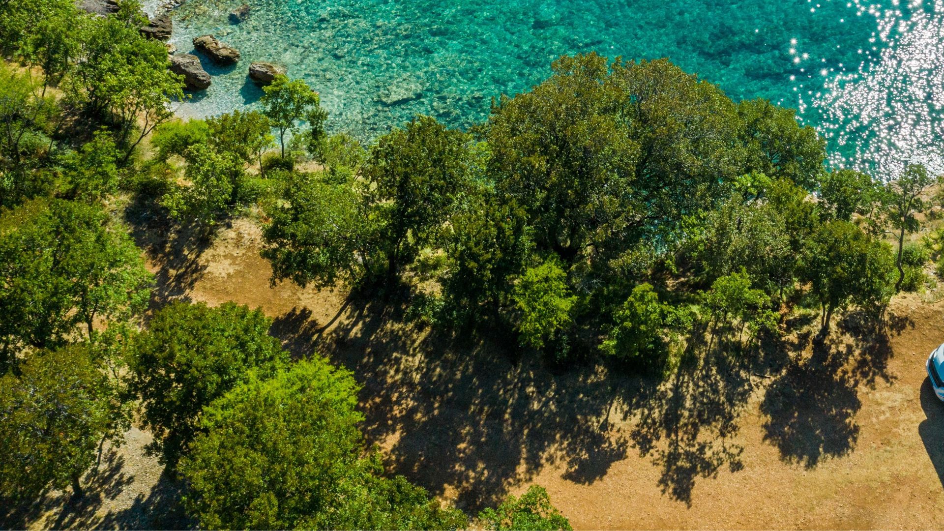 Aerial Photo of Scenic Sea Front RV Campsite. Modern Motorhome Camper Van on the Mediterranean Sea Croatian Coast. Vacation on the Road. Turquoise Bay.