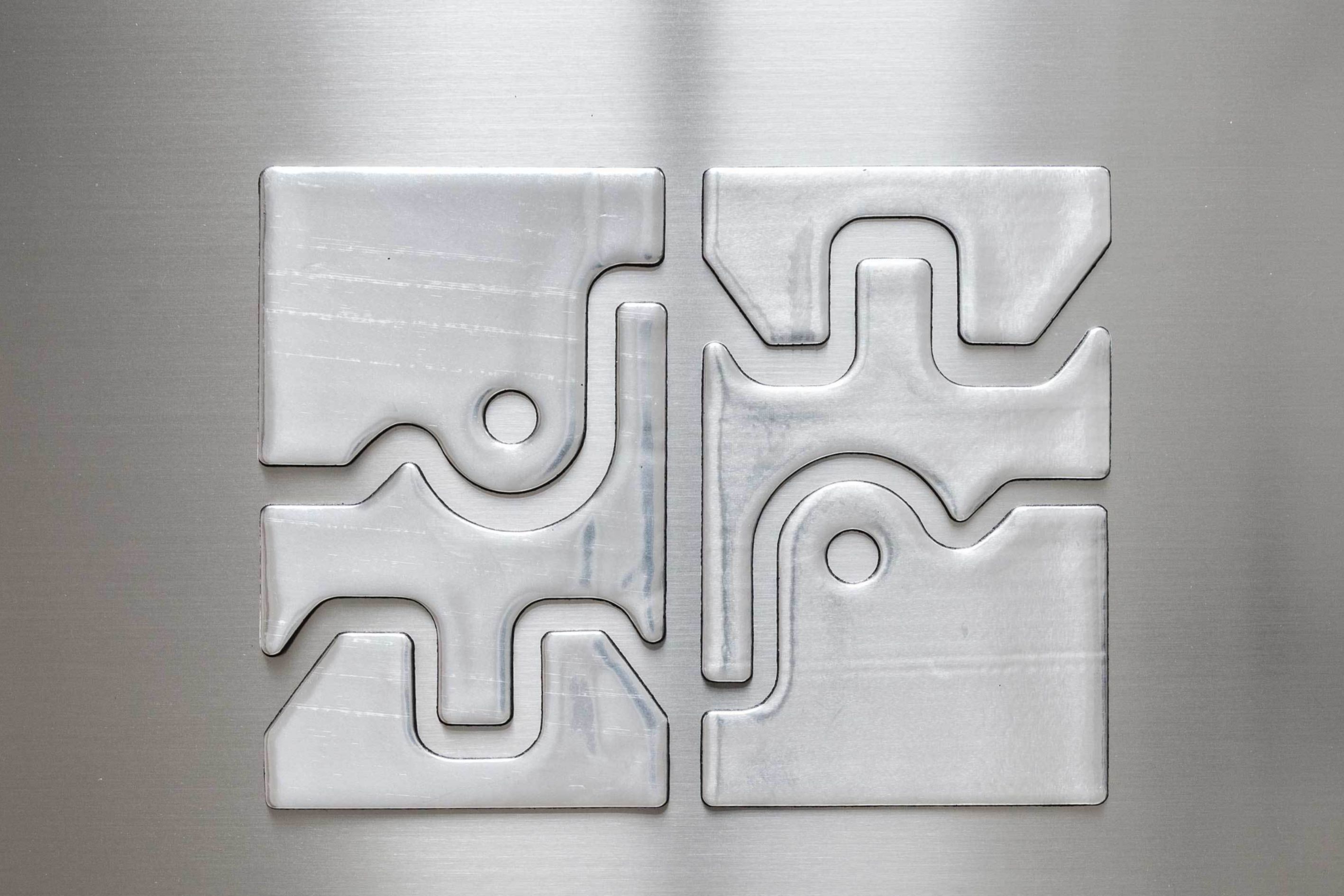 Metal substrate with custom die cut constrained layer damping