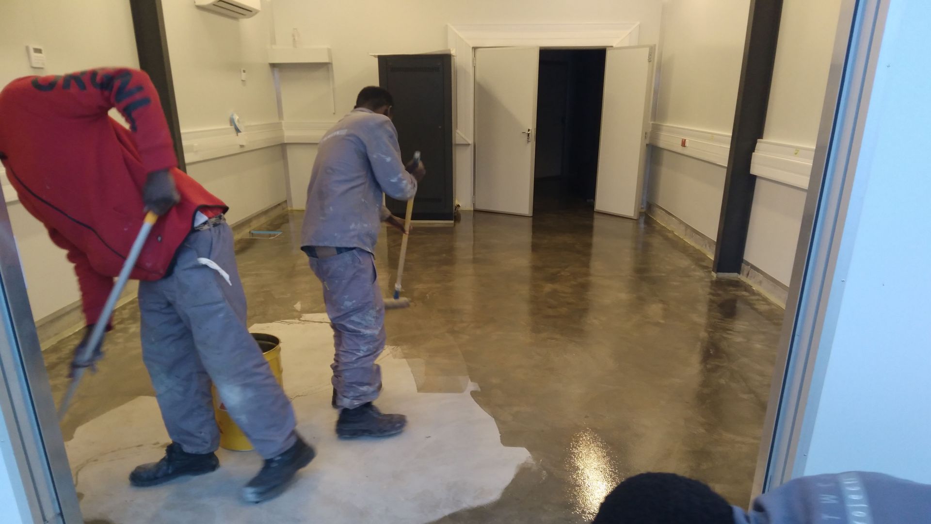 Men applying epoxy floor at SALT in Sutherland, South Africa