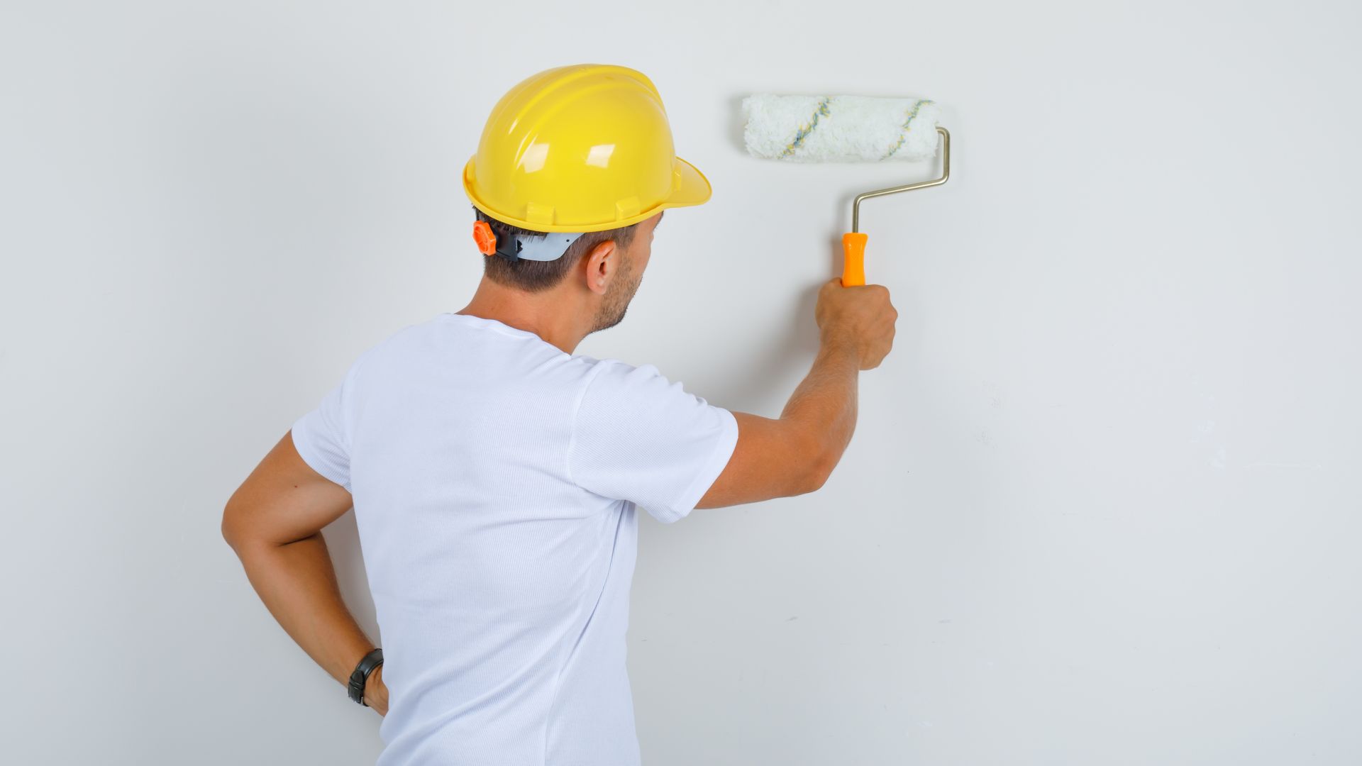 El trabajador aplicando pintura impermeabilizante a la pared del