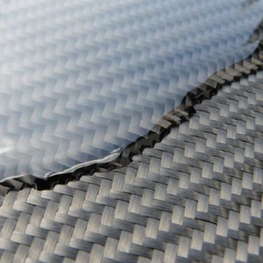 Composite resin flowing over a finished sheet of carbon fiber