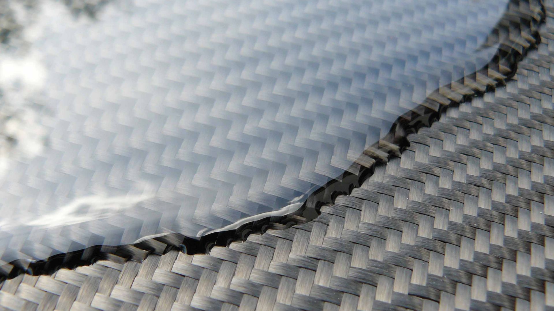 Composite resin flowing over a finished sheet of carbon fiber