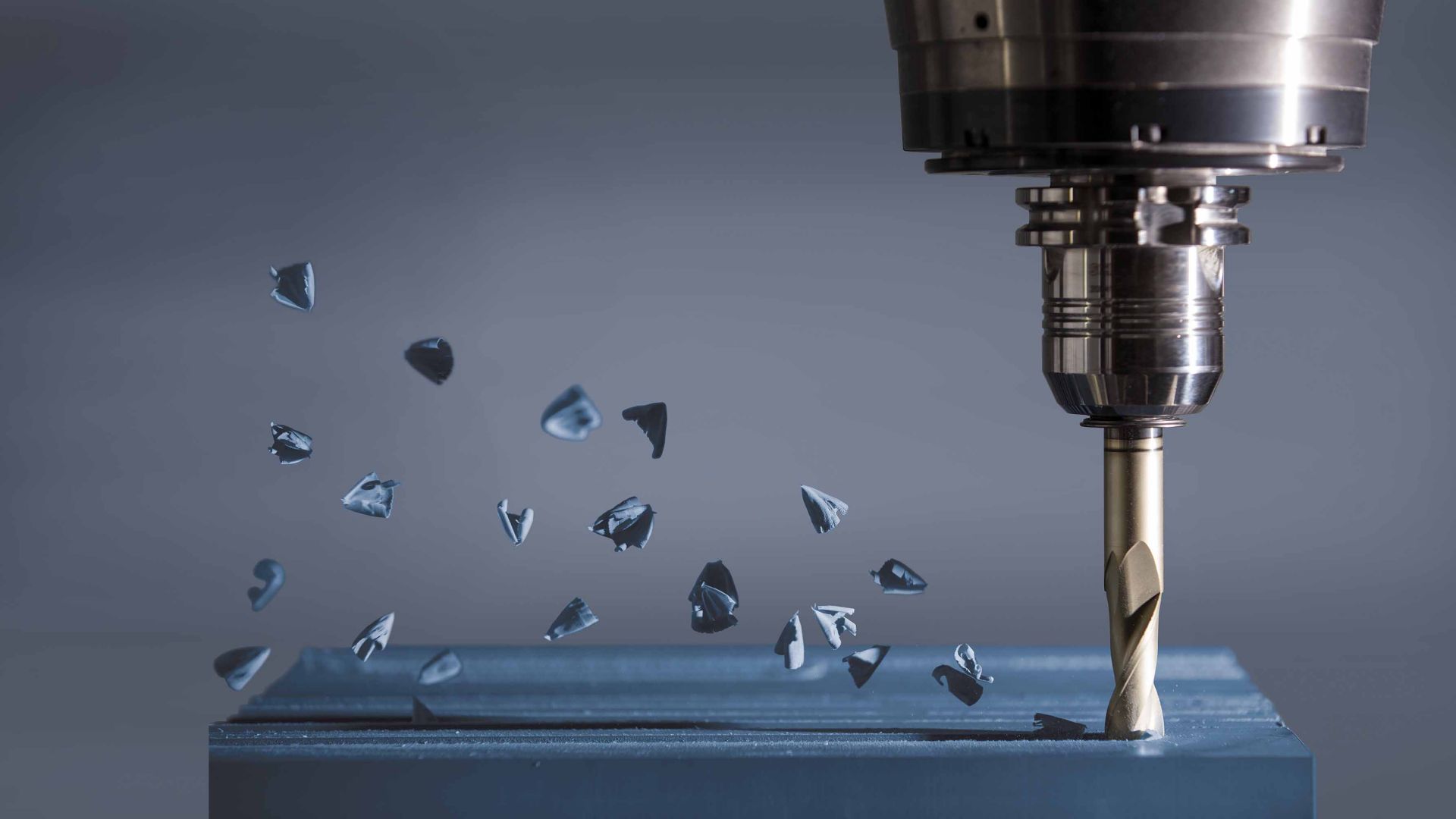 CNC router milling down a tooling board with chips being created