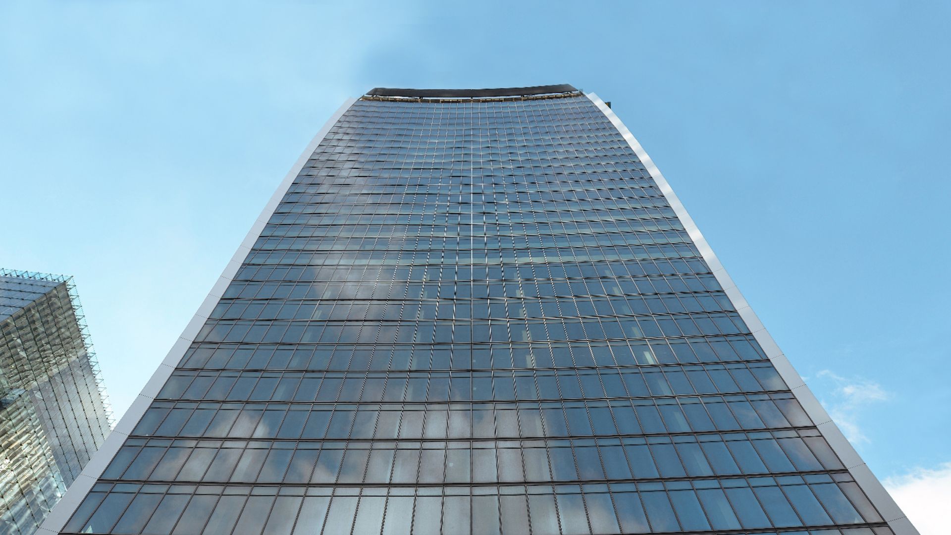 High-rise building with glass facade with cloud reflection