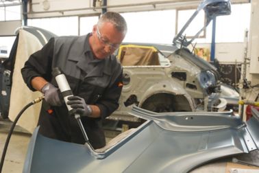 Car body repair with adhesive in a car factory 