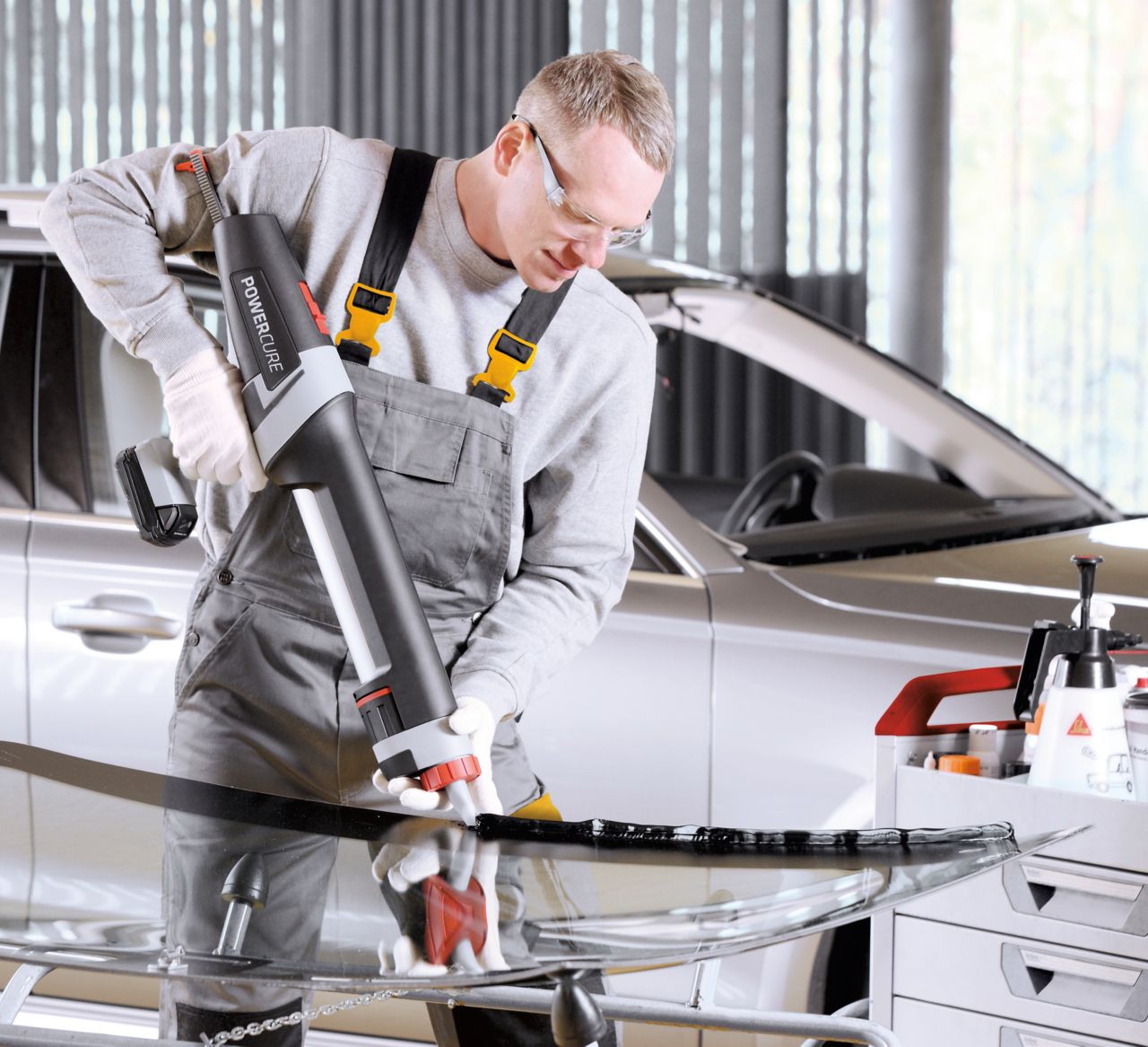 Automotive Aftermarket car glass replacement application with a manual gun containing adhesive