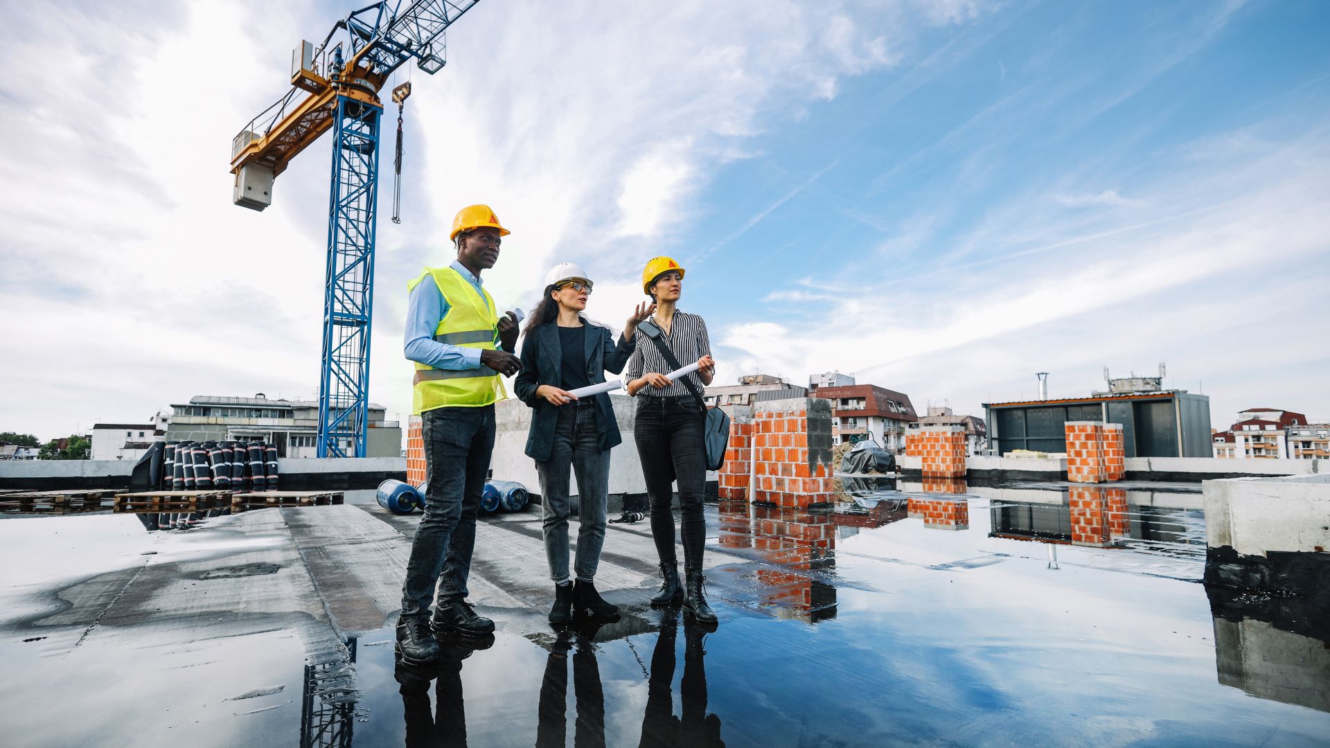 Architects and investors meeting at the construction site, on top of the residential building under construction.