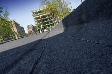 Close up view of bitumen membrane applied on roof at parapet