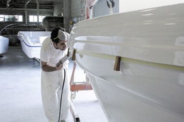 Man performing a deck to hull application on a yacht