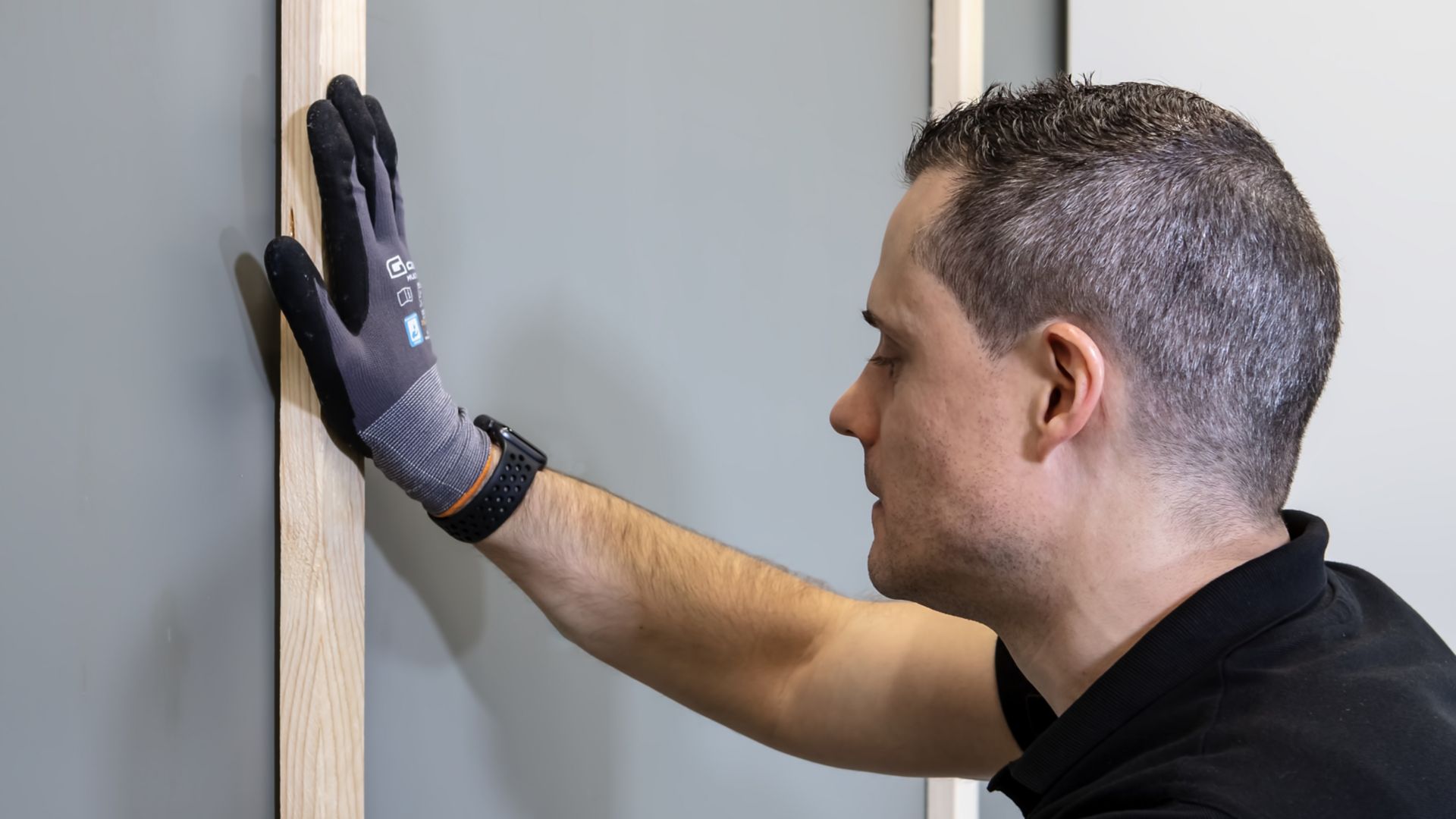 Attaching wood framework to wall after bonding product has been applied