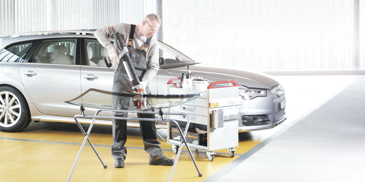 Automotive Aftermarket auto glass replacement application with a manual gun containing adhesive 