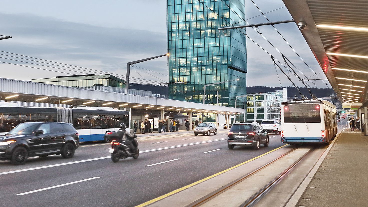 Street with cars busses and buildings