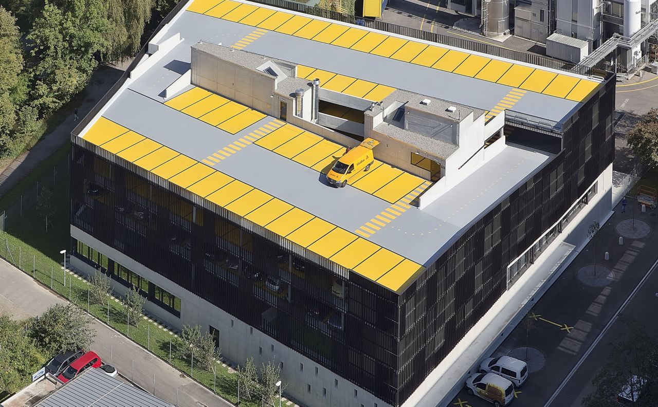 Car on  top floor of parking garage made with Sikafloor coating system