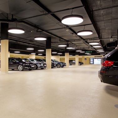 Cars in indoor parking garage made with Sikafloor coating system
