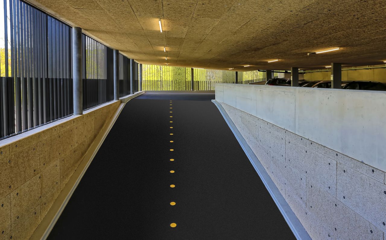 Car park ramp with yellow dot divider in parking garage in Switzerland