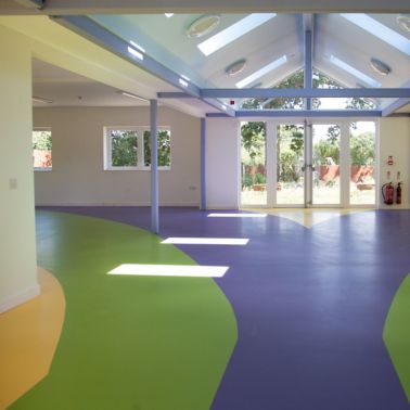 Sika ComfortFloor® blue, green, yellow floor at Rainbow House Charity in UK