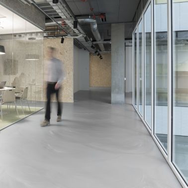 Sika ComfortFloor® grey marbled floor in office hallway
