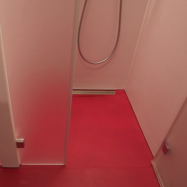 Sika ComfortFloor® pink bathroom shower in modern office building