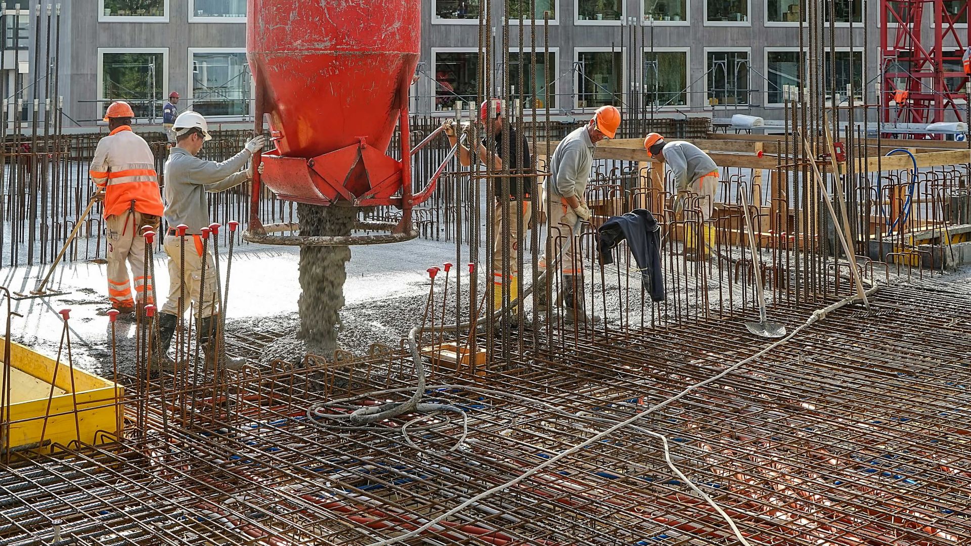 Worker men pouring fresh concrete into rebar for Limmat building in Zurich, Switzerland