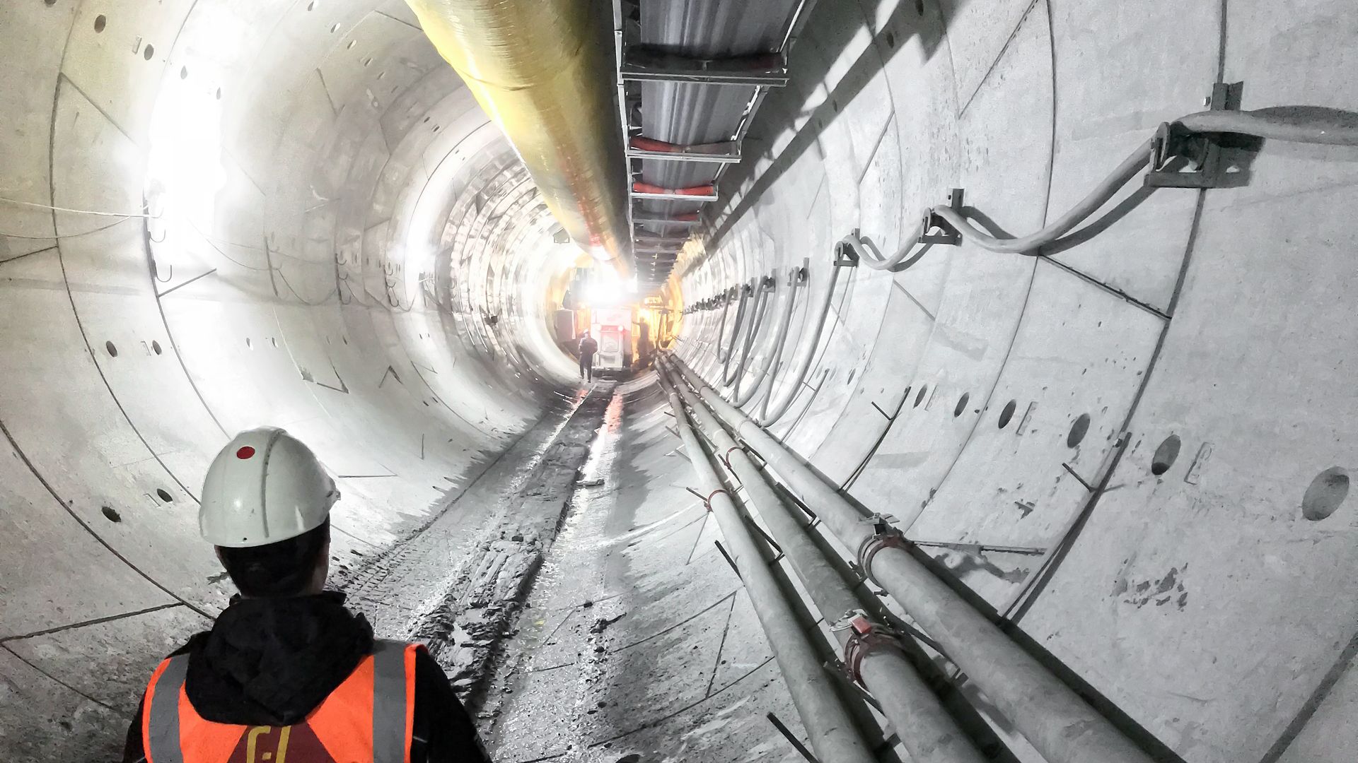 Sika man standing in concrete tunnel built with tunnel boring machine pipes and Sika concrete admixtures