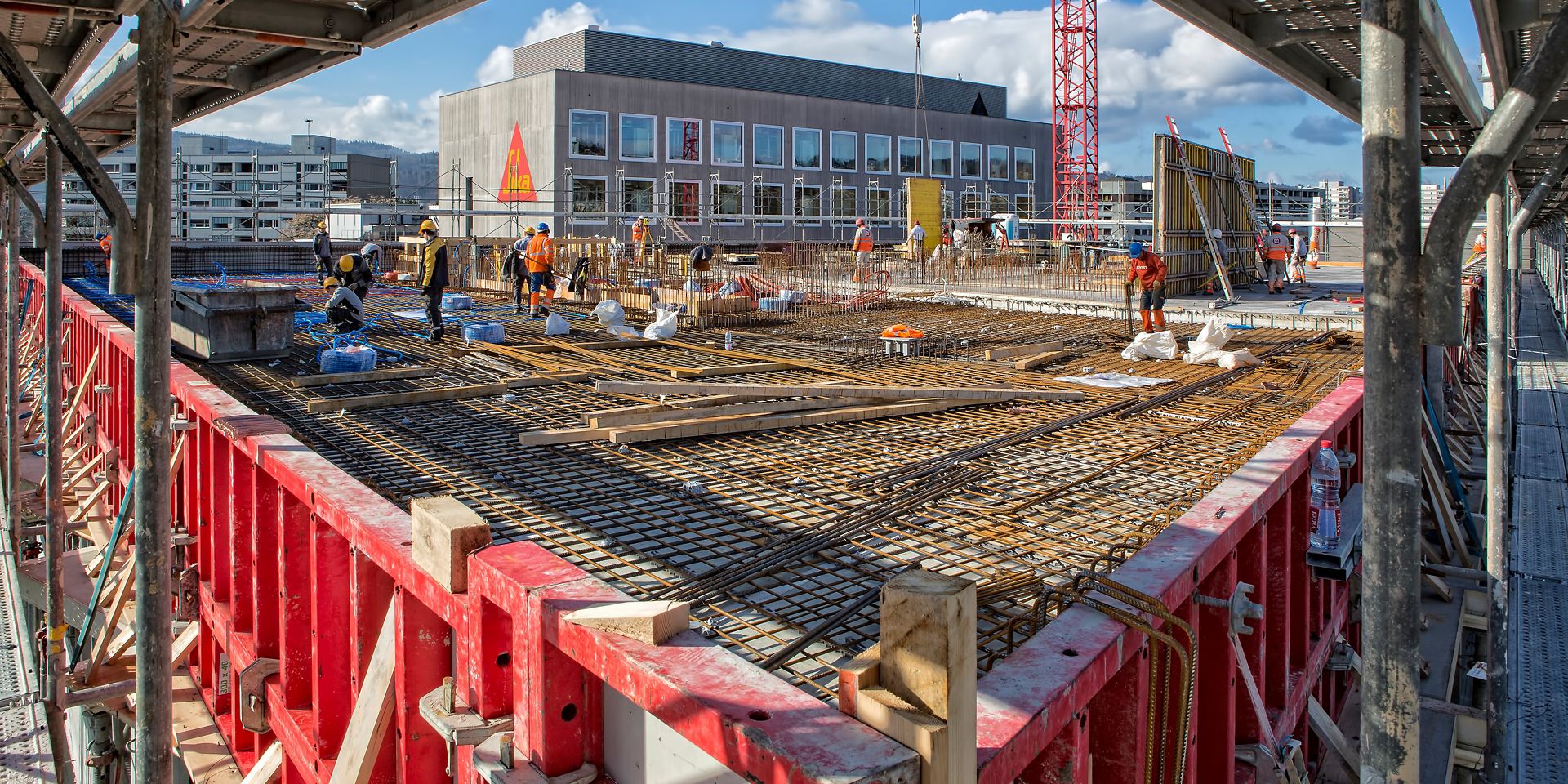 Workers setting up rebar to pour concrete floor on construction site at Limmat building in Zurich