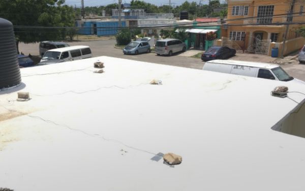 White membrane of cool roof system on residential building