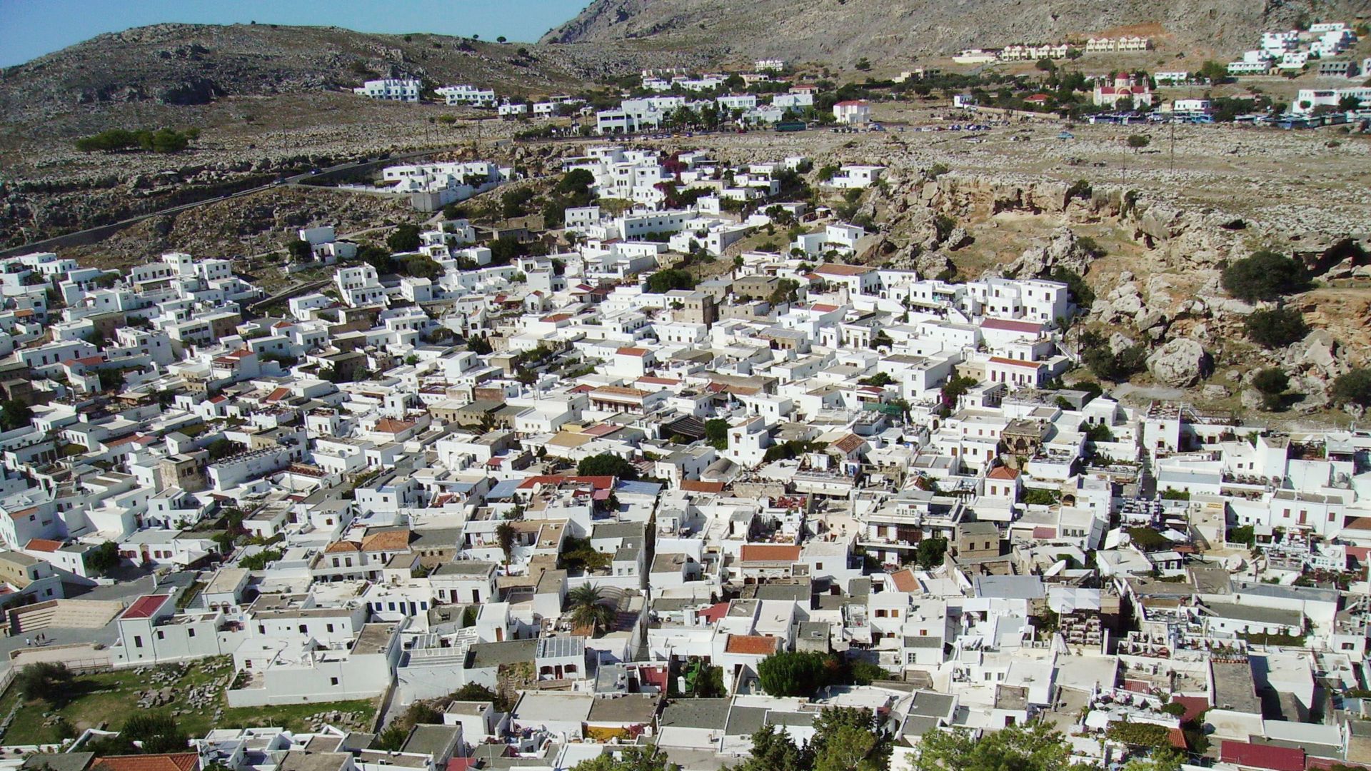 City in Greece where houses have cool roofs covered with white reflective roofing membrane