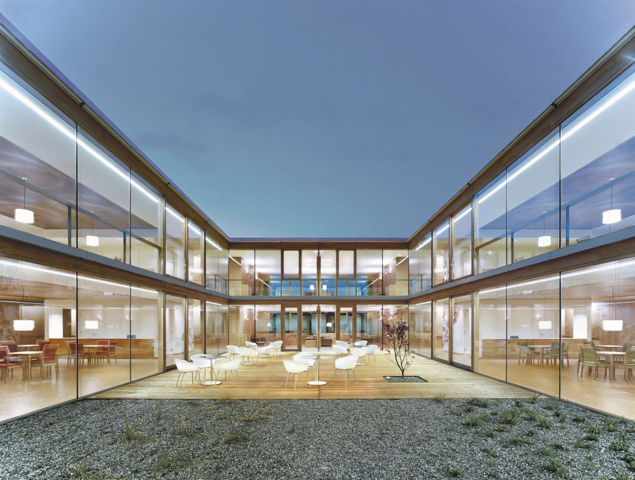 Seating area on terrace courtyard with glass facade