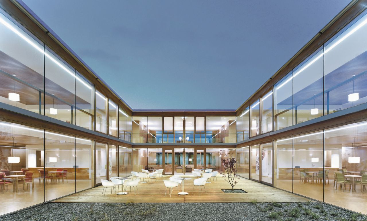 Seating area on terrace courtyard with glass facade