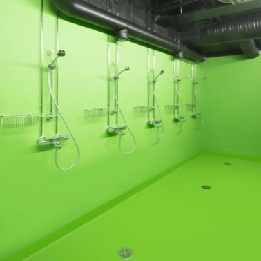 Decorative green bathroom shower floor at Kokkola campus hall school in Finland with Sika ComfortFloor system