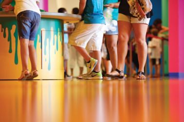 People standing on decorative orange floor made with Sika ComfortFloor system