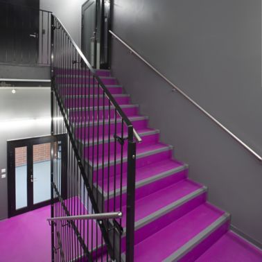 Decorative purple fushia stair floor grey walls at Kokkola campus hall school in Finland with Sika ComfortFloor system