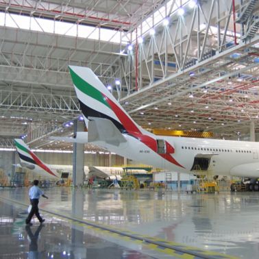 Dubai International Airport Emirates hangar with planes and man walking