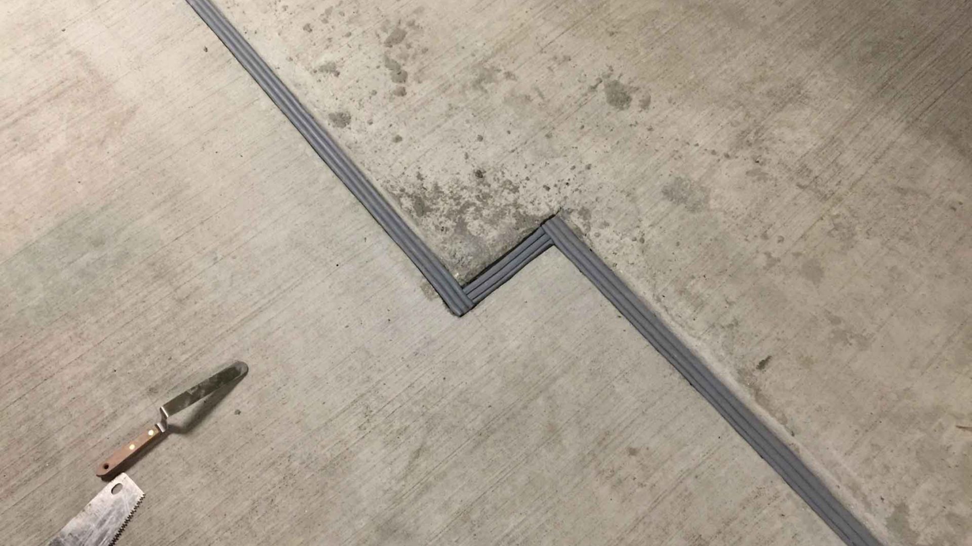 Sika Emseal grey expansion joint at concrete transition in Madison Wisconsin