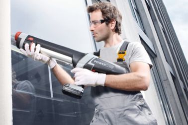 Man applying with Sika PowerCure dispenser glue to a facade