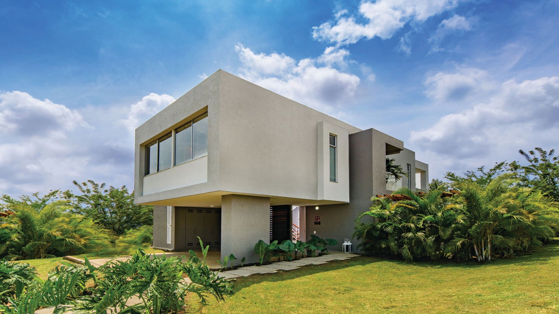 Facade mortar applied on modern house with grass and blue sky