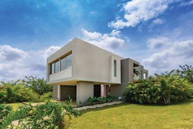 Facade mortar applied on modern house with grass and blue sky
