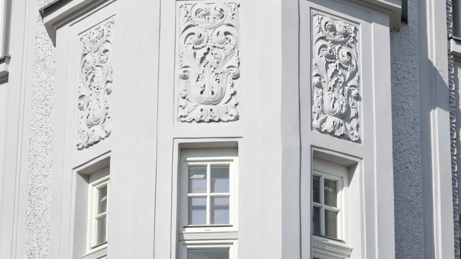 Historical house renovated white color facade detail in Karvina, Czech Republic