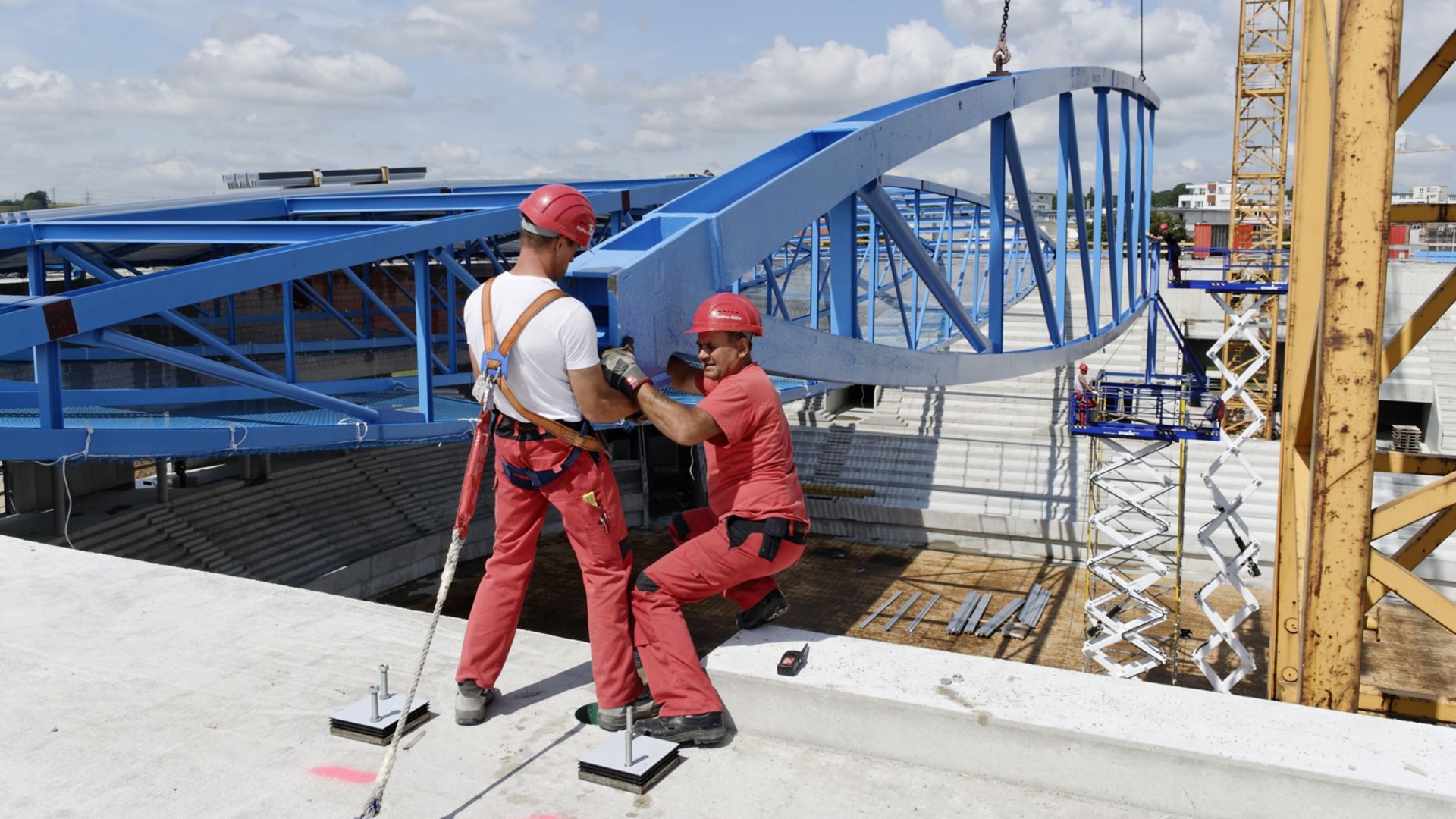 Men installing steel truss beam with Sika intumescent fire resistant coating