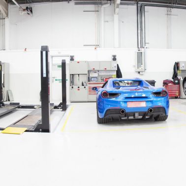Ferrari cars in repair workshop parked on floor coated with Sika Multidur system
