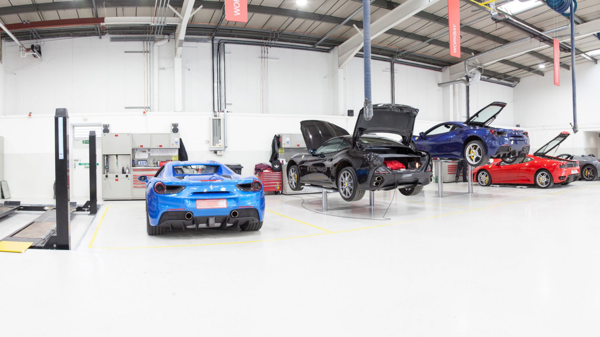 Ferrari cars in repair workshop parked on floor coated with Sika Multidur system