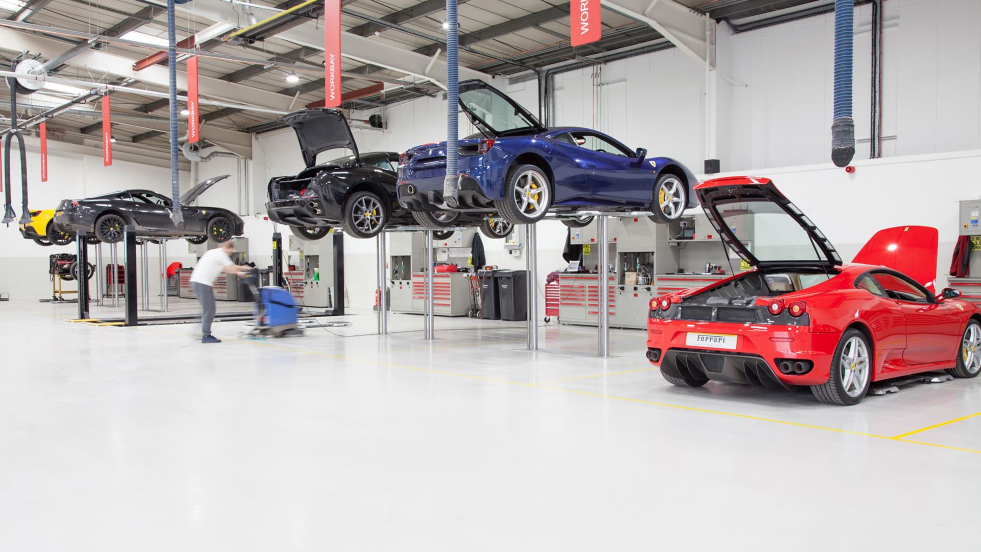 Ferrari cars in repair workshop parked on floor coated with Sika Multidur system