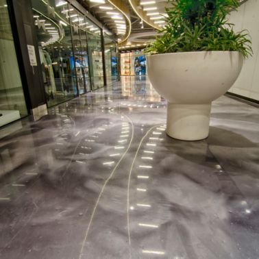 White plant vase on metallic floor in DFO Homebush shopping center