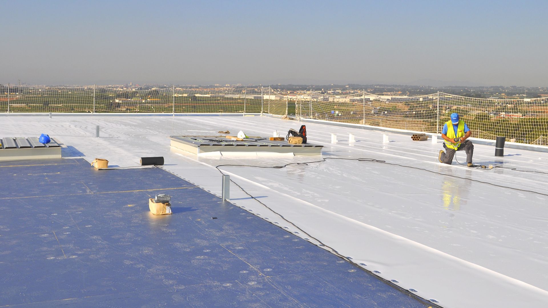 Man working on the roof Fruit Packaging House of Frutinter Company
