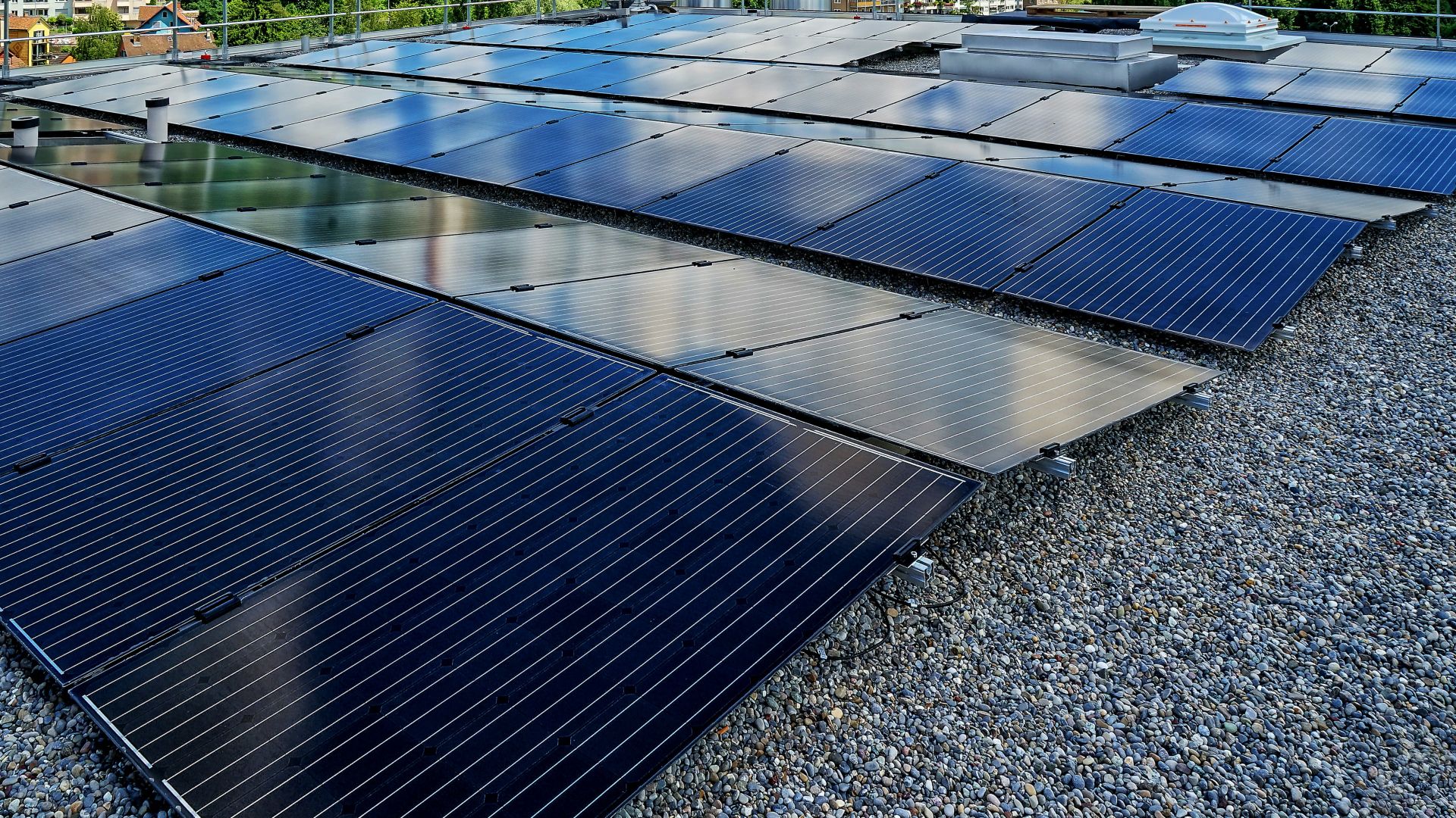 Solar panels on gravel ballasted roof with single ply membranes