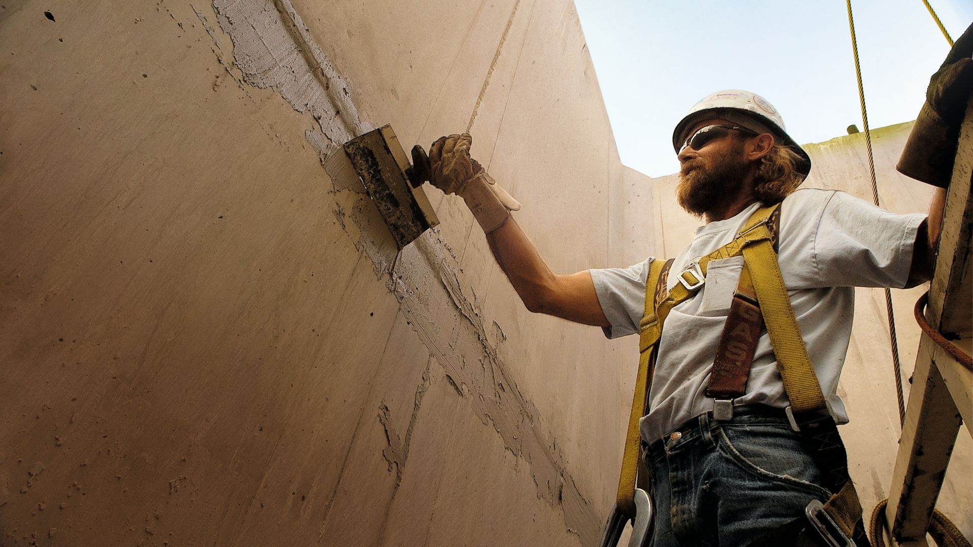 Man applying concrete repair mortar at Hoover Dam bypass bridge project