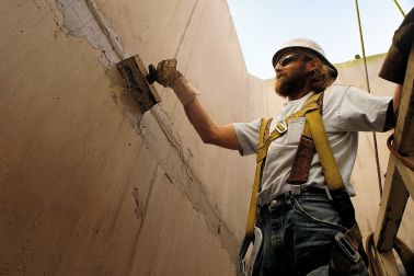 Man applying concrete repair mortar at Hoover Dam bypass bridge project